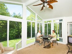 A large room with many windows and chairs.