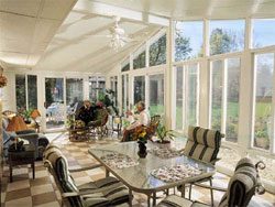 A large room with many windows and chairs.